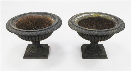 A pair of black painted cast iron garden urns, W.1ft 9in.